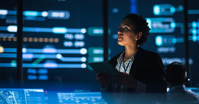 oung Multiethnic Female Government Employee Uses Tablet Computer in System Control Monitoring Center